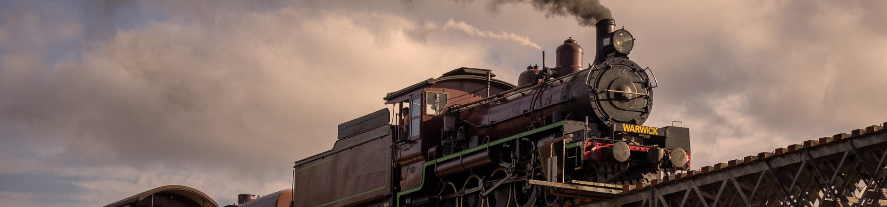 image of steam train chugging on tracks