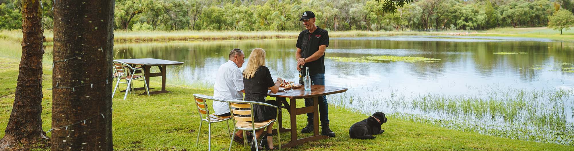 man serving customers a table