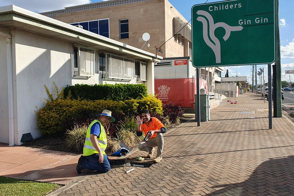 Picture contains a photograph of a smart water meter being installed in Bundaberg.